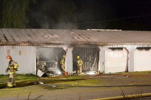 Firefighters from Fire District 3 survey the scene at Sellin’ Style car dealership in Blyn. Clallam County Sheriff’s Office officials say 57-year-old José Noe Torres allegedly started the fire.
