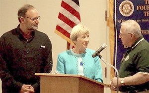 Sequim Sunrise Rotary president Jerry Sinn presents Jan Tatom and Mark Connelly