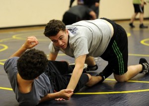 Shaun Jones takes down Sven Wiker during the first week of practice for the Wolves wrestling team. Coaches anticipate the team will return to winning after two winless dual-meet seasons.