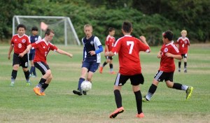Storm King Lightning’s Brandon Wagner chips a pass through the Nortac Sparta Red defense in an Aug. 7 matchup at the 2016 Dungeness Cup. Storm King topped Nortac Sparta