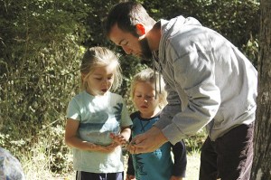 Brothers Jonathan and Jasper Tipton practice matching plants with their leaves during a morning lesson at Owl's Hollow Nature School with teacher Joshua Sylvester.