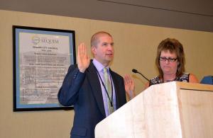 New Sequim City Manager Charlie Bush takes his oath of office on Aug. 24 at the Sequim City Council meeting from Sequim City Clerk Karen Kuznek-Reese.