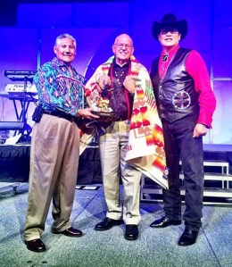 Presenting an award to W. Ron Allen (center) is Mark Chino