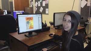 Sequim High School sophomore Breyanna Taylor looks over her winning piece for the Sequim Education Foundation’s 2015 Student Film Festival poster design contest.