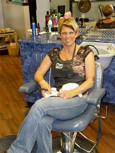 Stylist Kristen Eshom pauses in her busy day at her new business