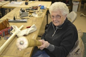 Arla Mohnkern shows off one of her decorative canes she makes with the Pacific Northwest Wood Artisans in the club's workshop last year.