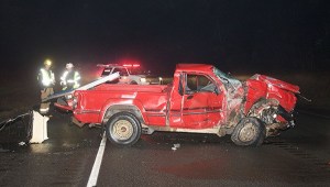 Clallam 2 Fire-Rescue personnel examine the scene of a two car accident west of Port Angeles Tuesday.