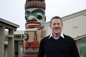 Mac Macdonald stands near the Jamestown S'Klallam Tribe's totem pole at the Jamestown Family Health Clinic. Macdonald
