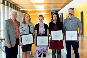 Peninsula College President Dr. Luke Robins stands next to John and Suanne Roueche Excellence Award winners