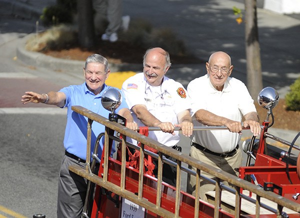 Clallam County Fire District 3 chiefs wave to the crowd at Clallam County Fire District 3’s centennial celebration parade in August. They are
