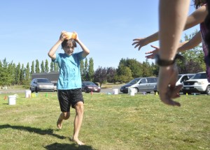 Eion Beglyakov is off to the races as he and teammates compete in a water relay race last week. Sequim Gazette photo by Michael Dashiell
