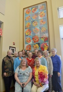 Some of the quilters with the Sunbonnet Sue Quilt Club who made “Flower Power” stand inside the OMC Cancer Center for a dedication on May 20. Those at the ceremony include