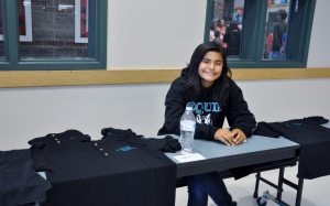 Seventh-grader Maria Asselin is ready to hand out band polo shirts during Timberwolf Days in Sequim Middle School’s cafeteria on Aug. 22. Photo by Patsene Dashiell