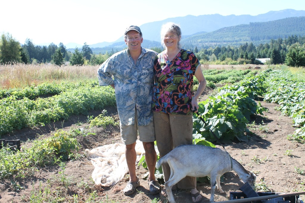 Farmer of the Year Doug Hendrickson and farm co-owner Lee Norton stand with one of their goats. Submitted photo
