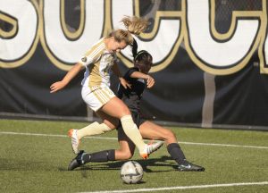 Peninsula's Marriah Perez gets deep into Shoreline territory in the second half of the Pirates' 3-0 home victory on Sept. 28. Perez had an assist in the victory. Dolphin Kayla Holland defends the play. Sequim Gazette photo by Michael Dashiell