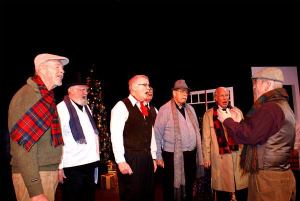 The men’s chorus performs a rousing rendition of “Jingle Bells.” From left are Dennis Western