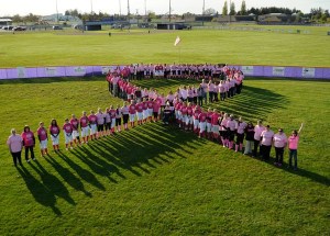 High school softball players and community members gather for a photo at the 2014 “Pink Up” event in Sequim.