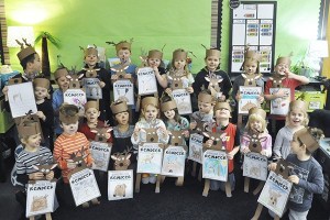 Stephanie Grotzke Nash’s kindergarteners proudly hold up their finished reindeer reports.