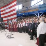 A combined chorus consisting of members of the Olympic Peninsula Men&rsquo;s Chorus, The Grand Olympics Chorus of Sweet Adeline&rsquo;s International, Mix Up A Capella and the Sequim High School Select Choir perform under the direction of Jim Davis during last Friday&rsquo;s Veterans Day ceremony in the hanger of U.S. Coast Guard Air Station/Sector Field Office Port Port Angeles. (Keith Thorpe/Peninsula Daily News)