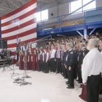 A combined chorus consisting of members of the Olympic Peninsula Men&rsquo;s Chorus, The Grand Olympics Chorus of Sweet Adeline&rsquo;s International, Mix Up A Capella and the Sequim High School Select Choir perform under the direction of Jim Davis during last Friday&rsquo;s Veterans Day ceremony in the hanger of U.S. Coast Guard Air Station/Sector Field Office Port Port Angeles. (Keith Thorpe/Peninsula Daily News)