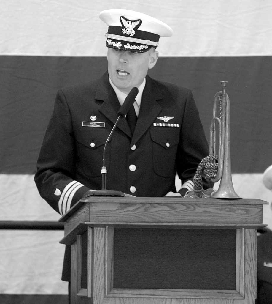 Keith Thorpe/Peninsula Daily News A family heirloom bugle graces the dias as U.S. Coast Guard Cmdr. Mark Hiigel, commanding officer of Air Station/Sector Field Office Port Angeles, speaks during Friday&rsquo;s Veteran&rsquo;s Day ceremony.