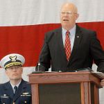 Retired U.S. Coast Guard Rear Adm. Richard Gromlich, right, delivers the keynote address during last Friday&rsquo;s Veterans Day ceremony in the hanger of U.S. Coast Guard Air Station/Sector Field Office Port Port Angeles. Looking on at left is Cmdr. Mark Hiigel, commanding officer of the station. (Keith Thorpe/Peninsula Daily News)