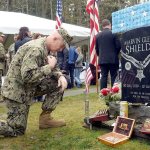 Capt. Christ Kurgan crosses himself beside the grave of Medal of Honor recipient Marvin Shields during the annual Veterans Day ceremony at the Gardiner Cemetery on Friday. Photo by Cydney McFarland/Peninsula Daily News