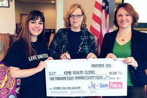 VIMO representative Mary Hogen, center, receives a donation check from Jig and Lure Fish Company employees Sarah Bolen, left, and Christina Fenner at the Soroptomist meeting on Nov. 11. Submitted photo