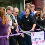 Len Borchers, Olympic Peninsula YMCA CEO, cuts the ribbon during the grand opening of the YMCA of Sequim on Sunday. (Jesse Major/Peninsula Daily News)