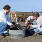 Scientists Robert Jeters and George Bonheyo with the Pacific Northwest National Laboratory in Sequim investigate an absorbent pad to see how much oil is leftover after it was burned using an aggregator product to promote burning. Sequim Gazette photo by Matthew Nash