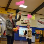 Allie Rush, 9, a fourth-grader, juggles with her mom Melissa Gatchet during conferences at Helen Haller Elementary to demonstrate how the Heart Tech Plus program works. It&rsquo;s one of the programs the school&rsquo;s PTO is raising funds for at the Turkey Trot. Sequim Gazette photo by Matthew Nash