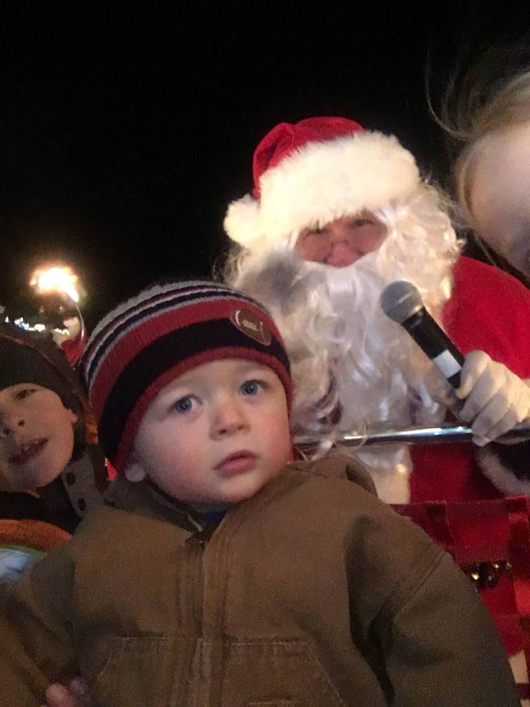 Mason Anderson enjoys a ride on an antique fire truck with Santa Claus and friends for the seventh annual Santa&rsquo;s Toy and Food Brigade.