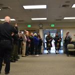 Sequim Police Chief Bill Dickinson gives his approval to the Seattle Police Pipes & Drums group as they enter a ceremony on Dec. 1 in the Sequim Transity Center honoring his 45 years in law enforcement. Sequim Gazette photo by Matthew Nash