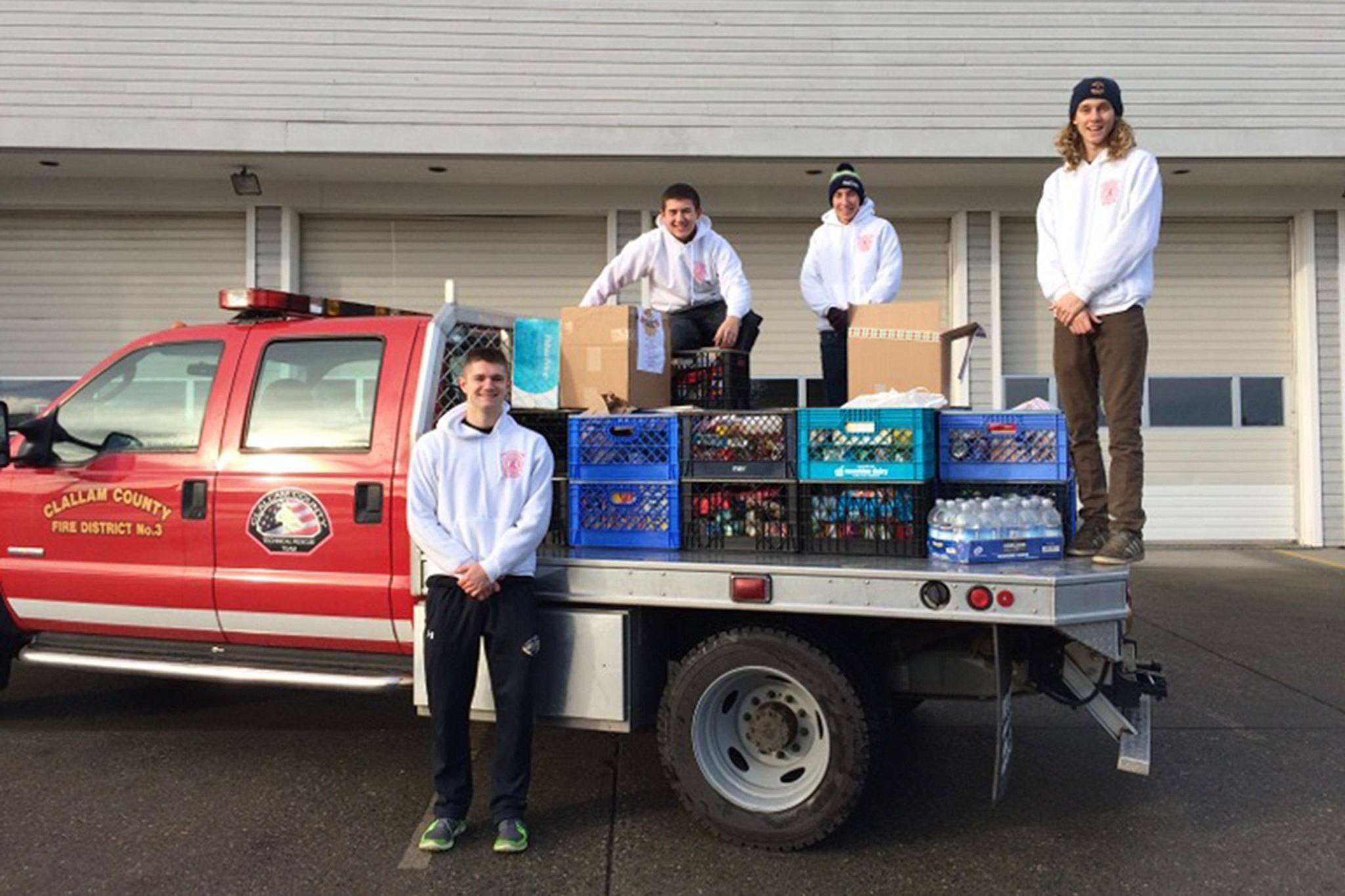 Explorer Post 1003 members, from left, Michael Larsen, Tyler Smith, Christian Goodrich and Curtis Beery stand with the community&rsquo;s donation of about 1,200 pounds of food. Photos courtesy of Leonard Horst