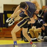 Sequim&rsquo;s Craig Baker takes North Kitsap&rsquo;s Zach Streun up and over in a 13-6 win, in the 145-pound weight class, as Baker&rsquo;s Wolves top NK 52-18 on Dec. 14. Sequim Gazette photo by Michael Dashiell