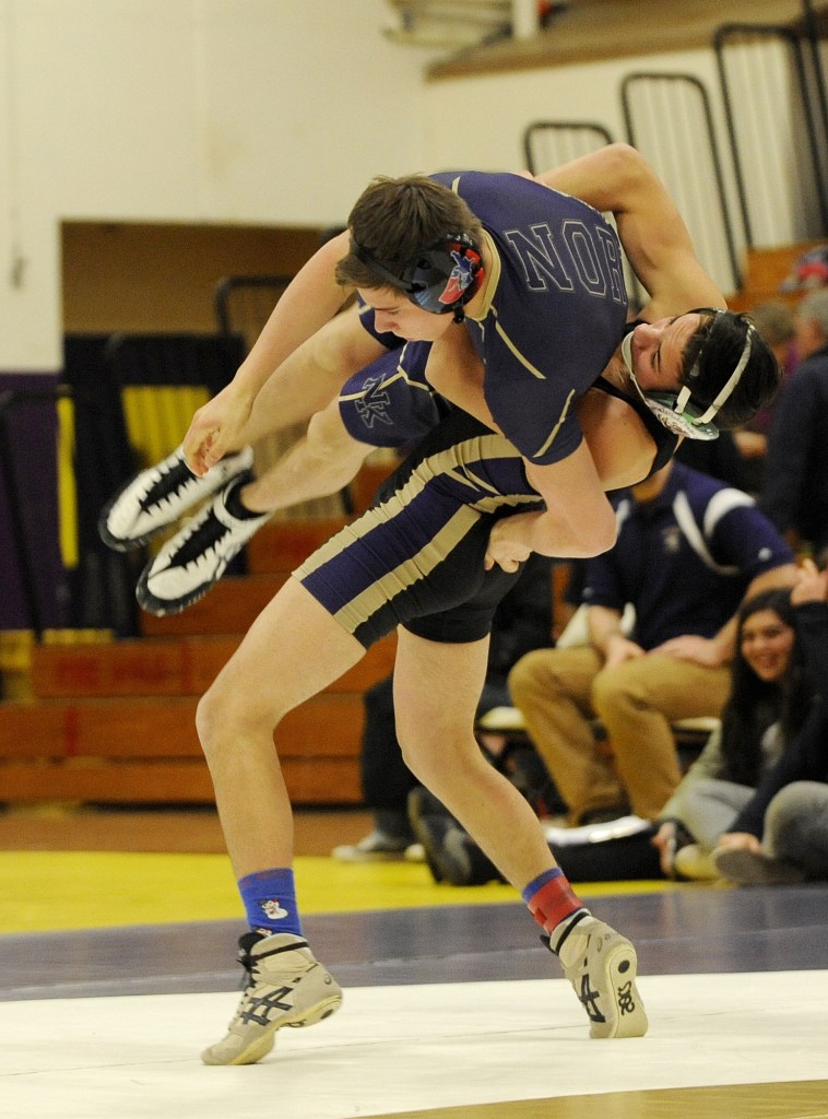 Sequim&rsquo;s Craig Baker takes North Kitsap&rsquo;s Zach Streun up and over in a 13-6 win, in the 145-pound weight class, as Baker&rsquo;s Wolves top NK 52-18 on Dec. 14. Sequim Gazette photo by Michael Dashiell