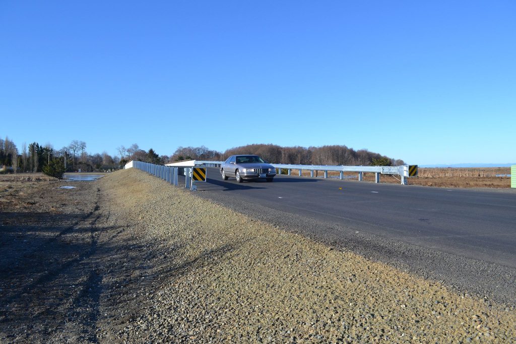 Sequim-Dungeness Way now travels farther east over Meadowbrook Creek over a new concrete bridge to make for better passage for salmon into the estuary below. The roadway intersects 3 Crabs Road, which has a cul-de-sac now by a viewing area that people can park by and access without a Discover Pass. Sequim Gazette photo by Matthew Nash