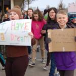 Eighth-grader Olivia Preston (left) showed a sign that read &ldquo;I Have a Dream&rdquo; while seventh-grader Jack Van de Wege (right) held a sign that says &ldquo;Injustice Anywhere is a threat to Justice Everywhere.&rdquo; Sequim Gazette photo by Erin Hawkins