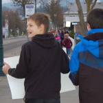 Seventh-graders Blake McGowan, left, held a sign that read &ldquo;Freedom To All! SMS&rdquo; while Perry Sharpes, right, shows a poster that read &ldquo;Honor King &mdash; End Racism&rdquo; during the Martin Luther King Jr. Day walk on the morning of Friday, Jan. 13. Sequim Gazette photo by Erin Hawkins