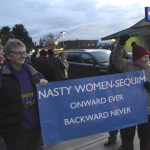 Kathi White and Donna Maclean hold one of the few signs up at the women&rsquo;s rights rally in downtown Sequim on Jan. 21. Maclean said their sign is a response to President Donald Trump calling his opponent Hillary Clinton a &ldquo;nasty woman&rdquo; at a debate.