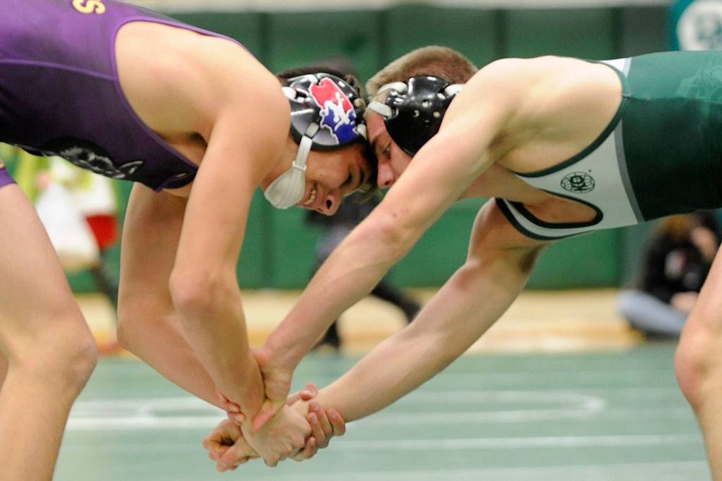 At 145 pounds, Sequim&rsquo;s Craig Baker and Port Angeles&rsquo; Ben Basden grapple in a tight match. Baker went on to win 9-5. Sequim Gazette photo by Matthew Nash