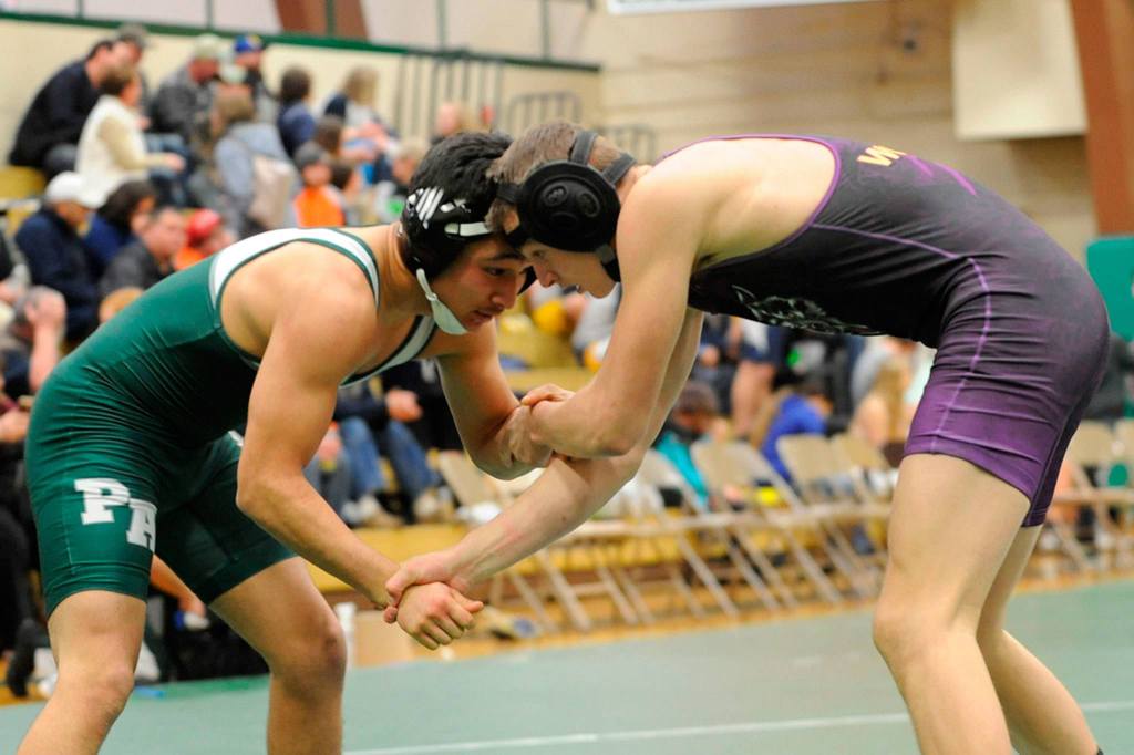 Rudy Valdez of Port Angeles and Sequim&rsquo;s Murray Bingham look to make a take down during the Battle for the Axe on Jan. 12. Bingham won the match 6-4. Sequim Gazette photo by Matthew Nash