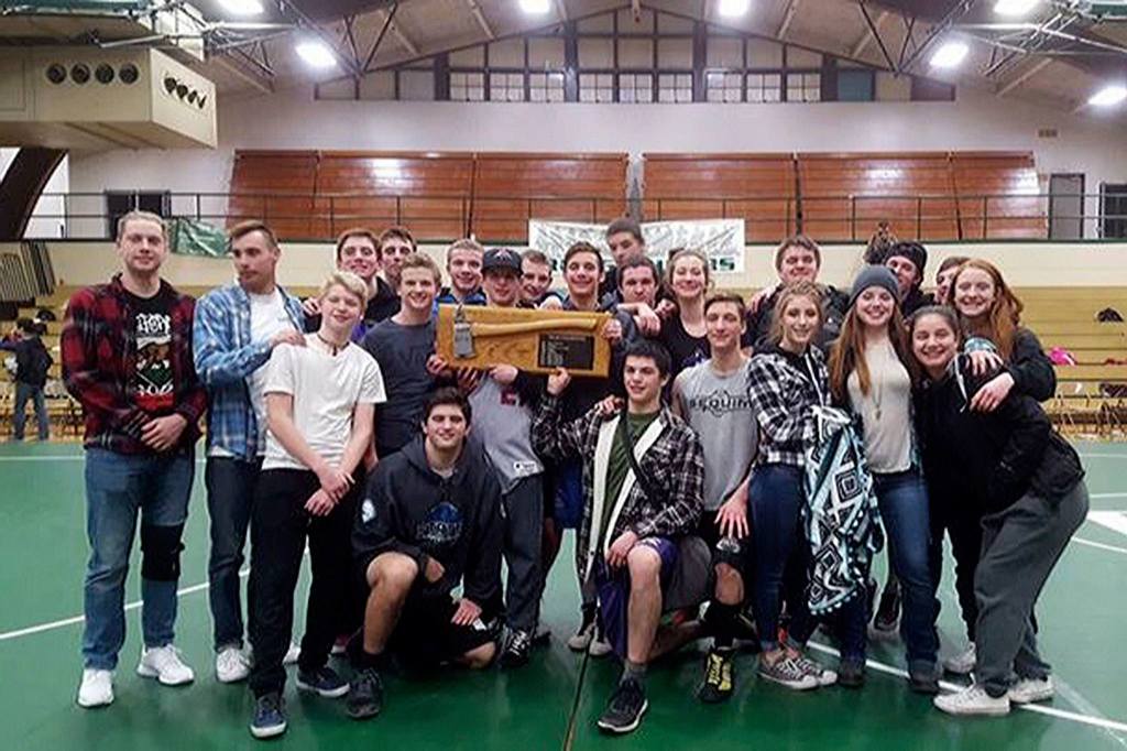 Sequim wrestlers and coaches hold the trophy from Port Angeles&rsquo; Battle for the Axe on Jan. 12. The Wolves took the title from Port Angeles after defeating them in the first round of a four-way dual that included Forks and Port Townsend.                                 Submitted photo