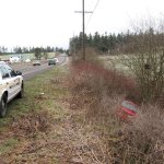 A Clallam County Sheriff&rsquo;s Office cruiser sits along Sequim-Dungeness Way above a Toyota Celica found along the roadway. A man walking a dog found the Toyota and called 9-1-1, leading to the rescue of a Sequim resident parked inside. (Brandon Stoppani/Clallam County Sheriff&rsquo;s Office)