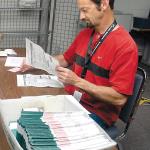 Clallam County Elections Supervisor Ken Hugoniot inspects ballots in August 2015 at the Clallam County Courthouse in Port Angeles. (Keith Thorpe/Peninsula Daily News)