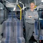 Clallam Transit operations manager Steve Hopkins stands in the aisle of a bus similar to the rolling stock being considered for a twice-daily run from Port Angeles and Sequim to Bainbridge Island. Keith Thorpe/Peninsula Daily News