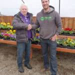 Roger Fell, a longtime nurseryman and owner of Peninsula Nurseries, shakes hands with George Peterson, who has purchased the business and the property. Sequim Gazette photo by Patricia Morrison Coate