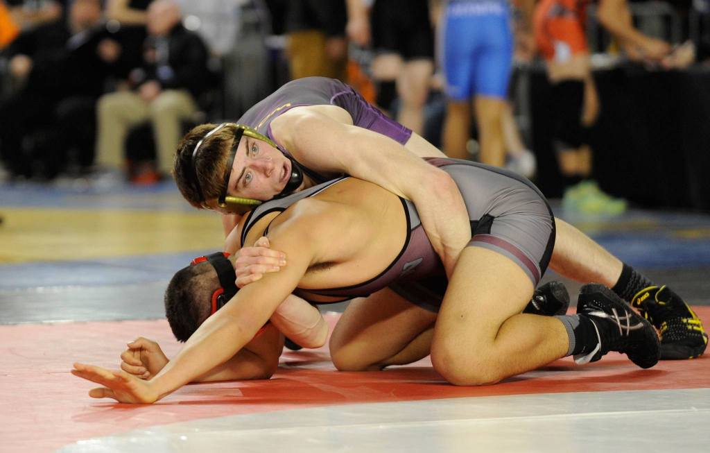 Grant Pierson attempts to take the first round matchup against E.J. Matagi of WF West at the MatClassic on Feb. 17. Pierson lost the match but went on to place fifth in the 160-pound boys bracket. Sequim Gazette file photos by Michael Dashiell