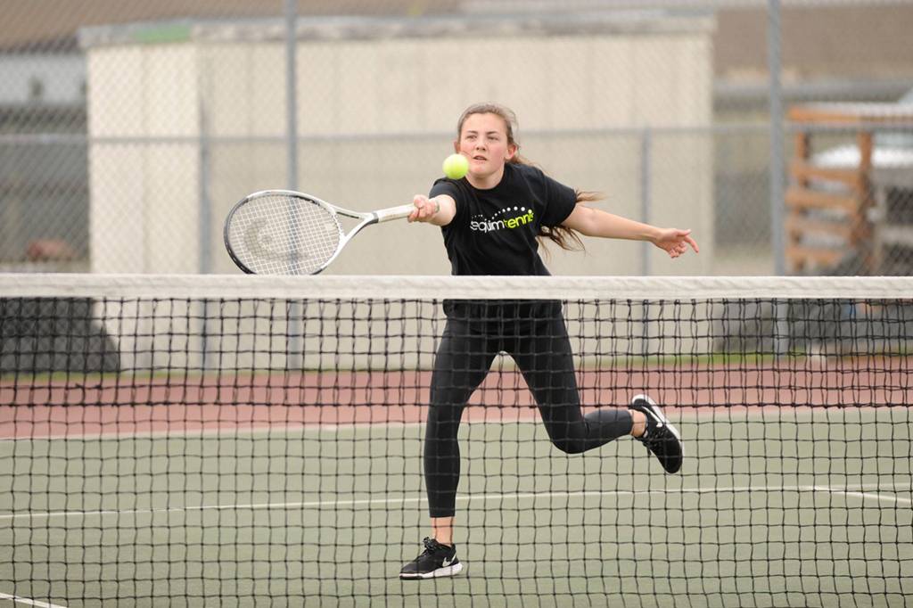 Ashley Rosales of Sequim makes a quick hit on Wednesday against Port Angeles&rsquo; No. 3 doubles team of Preetha Patel and Brielle Halberg. Rosales and teammate Amanda He won in two sets 6-4, 6-1. Sequim Gazette photos by Matthew Nash