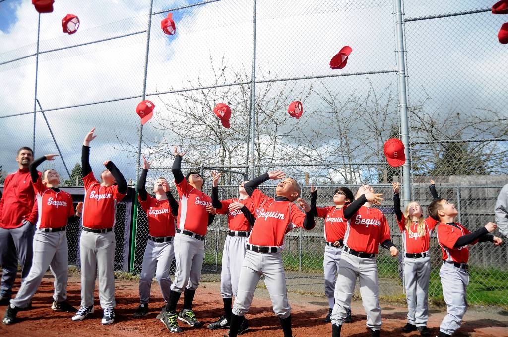 The Cherry Creek Mortgage team joins other squads in welcoming the 2017 Sequim Little League season Saturday, April 15, at James Standard Park. See more photos on A-14 and online at cmg-northwest2.go-vip.net/sequimgazette. Sequim Gazette photo by Michael Dashiell